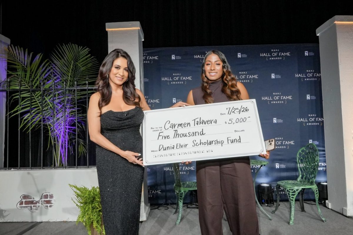 Dunia Elvir and Carmen Talavera hold a ceremonial $5,000 check from the Dunia Elvir Scholarship Fund at the NAHJ Hall of Fame Awards